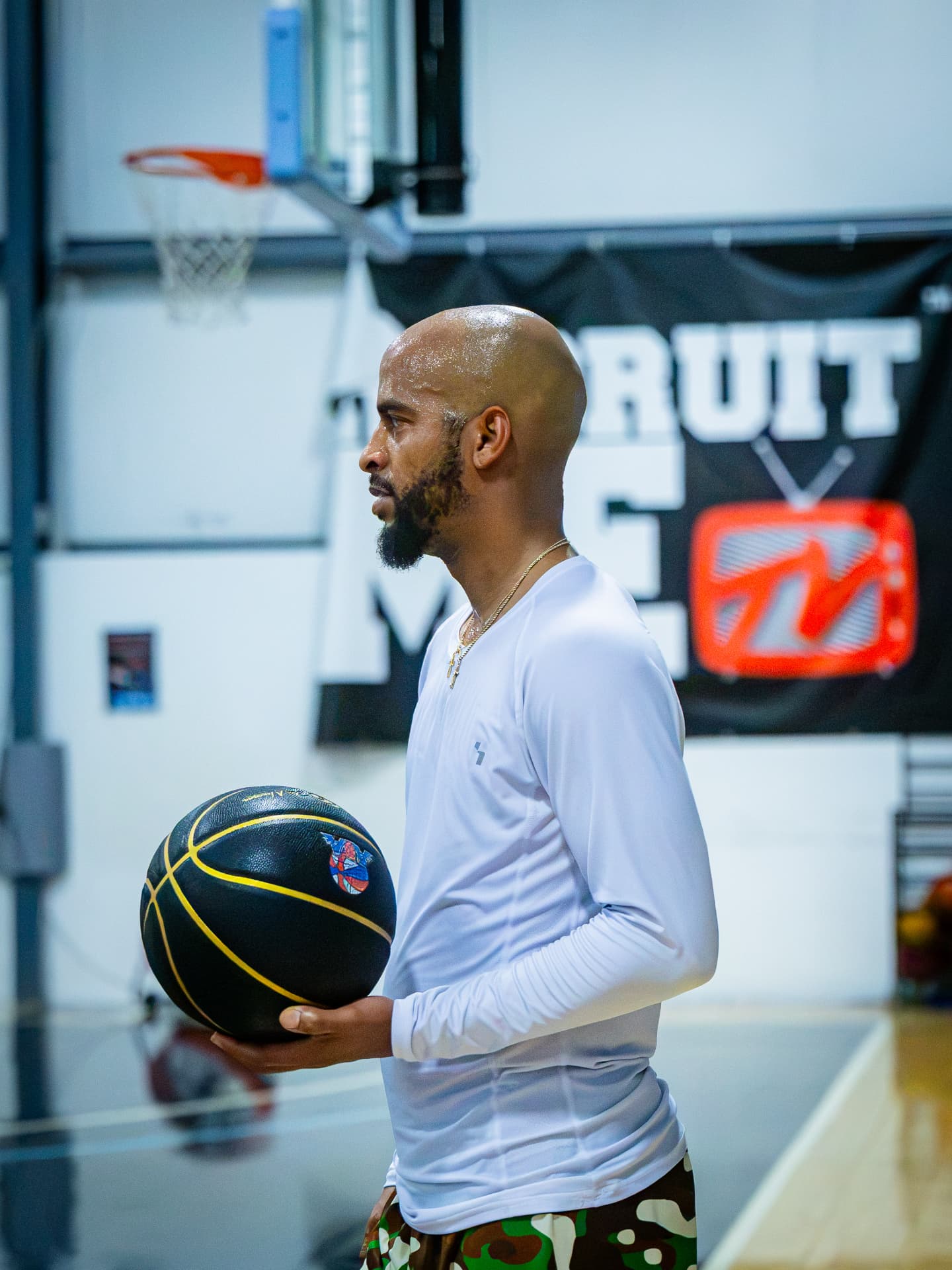 Kings coach watching practice with a basketball